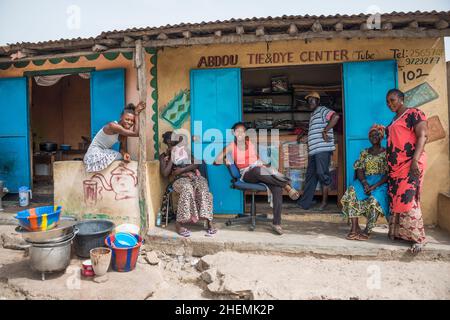 Group of people outside a grocery store on Tanji beach, The Gambia Stock Photo