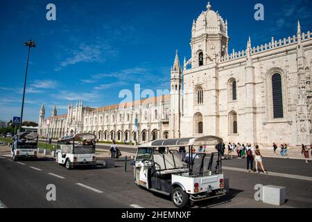 a Tuk Tuk Taxi in front of the Mosteiro dos Jeronimos in Belem near the City of Lisbon in Portugal.  Portugal, Lisbon, October, 2021 Stock Photo