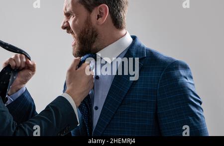 Experiencing aggression at work. Angry professional man fight with colleague. Workplace aggression Stock Photo