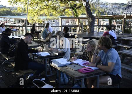 Austin, TX, USA. 27th Oct, 2021. Students and young professionals hang out at Mozart's Coffee on Lake Austin on a chilly Austin afternoon in the fall. The scene is popular because of its extensive outdoor patio overlooking the lake. (Credit Image: © Bob Daemmrich/ZUMA Press Wire) Stock Photo