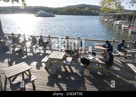 Austin, TX, USA. 27th Oct, 2021. Students and young professionals hang out at Mozart's Coffee on Lake Austin on a chilly Austin afternoon in the fall. The scene is popular because of its extensive outdoor patio overlooking the lake. (Credit Image: © Bob Daemmrich/ZUMA Press Wire) Stock Photo