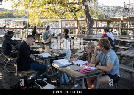 Austin, TX, USA. 27th Oct, 2021. Students and young professionals hang out at Mozart's Coffee on Lake Austin on a chilly Austin afternoon in the fall. The scene is popular because of its extensive outdoor patio overlooking the lake. (Credit Image: © Bob Daemmrich/ZUMA Press Wire) Stock Photo