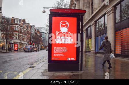 London, UK. 11th Jan, 2022. A display is seen on a bus stop on Oxford Street that informs people that they must wear a face covering on public transport as the Omicron variant of coronavirus continues to spread. (Photo by Vuk Valcic/SOPA Images/Sipa USA) Credit: Sipa USA/Alamy Live News Stock Photo