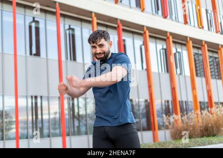 Young man doing their stretches before training. Stock Photo
