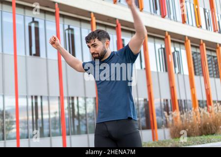 Young man doing their stretches before training. Stock Photo