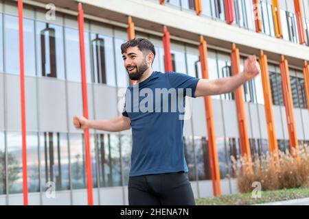 Young man doing their stretches before training. Stock Photo