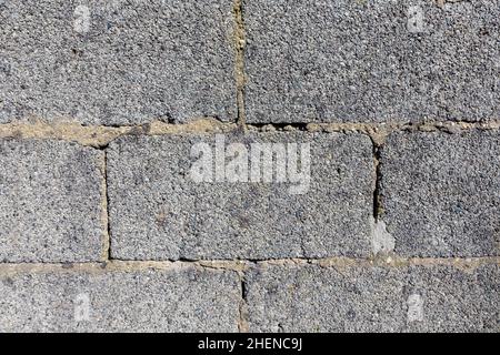 old wall with rough structure made of huge grey brick stones Stock Photo