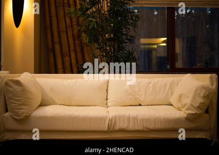 Photo of a modern sofa with pillows in a fashionable apartment Stock Photo