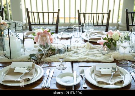 Table set up for outdoor wedding reception with elegant decor. Stock Photo