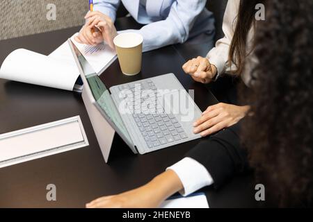 Unrecognized female office workers using digital tablet during a meeting. Stock Photo