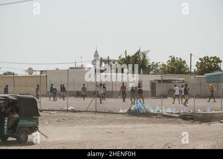 Djibouti, Djibouti - May 21, 2021: Djiboutian children playing football on the field in Djibouti. Editorial shot in Djibouti.. Stock Photo