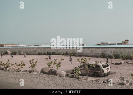 Djibouti, Djibouti - May 21, 2021: Djiboutian children playing football on the field in Djibouti. Editorial shot in Djibouti.. Stock Photo