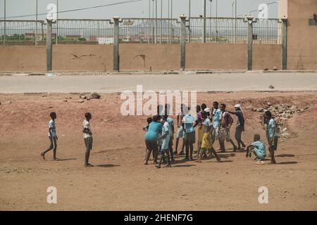 Djibouti, Djibouti - May 21, 2021: Djiboutian children playing football on the street in Djibouti. Editorial shot in Djibouti.. Stock Photo