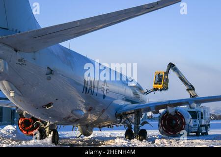 MISAWA, Japan (Jan. 5, 2022) – Aviation Electrician’s Mate Airman James Williams, assigned to the “Golden Swordsmen” of Patrol Squadron (VP) 47, operates a de-icing truck to remove snow and ice from a P-8A Poseidon at Misawa Air Base. VP-47 is currently deployed to Naval Air Facility Misawa, Japan conducting maritime patrol and reconnaissance and theater outreach operations within U.S. 7th Fleet (C7F) area of operations in support of Commander, Task Force 72, C7F, and U.S. Indo-Pacific Command objectives throughout the region. (U.S. Navy photo by Mass Communication Specialist 3rd Class Benjami Stock Photo