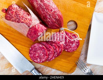 Salchichon, traditional spanish dry cured pork sausage on table Stock Photo