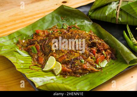 Meen Pollichathu or fish pollichathu, tasty kerala dish, fish with masala cooked in banana leaf. Stock Photo