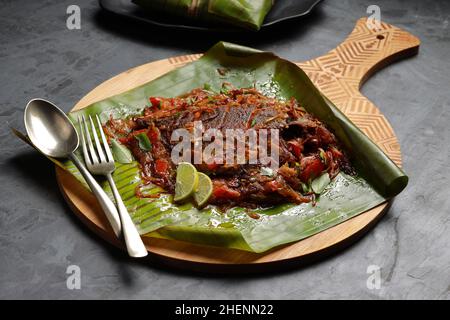 Meen Pollichathu or fish pollichathu, tasty kerala dish, fish with masala cooked in banana leaf. Stock Photo