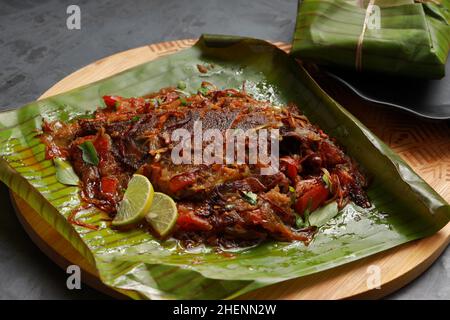 Meen Pollichathu or fish pollichathu, tasty kerala dish, fish with masala cooked in banana leaf. Stock Photo