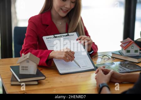 Client sign the documents to make the contract legally, Home sales and home rental real estate concept Stock Photo