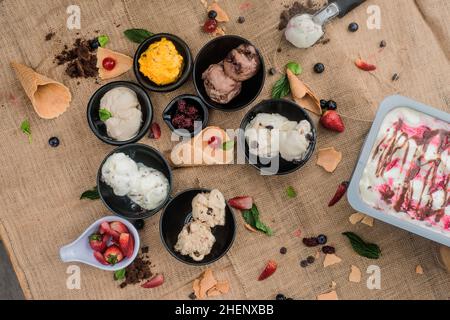 strawberry ice cream with chocolate, passion fruit and cherry Stock Photo