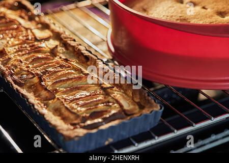 Apple pie and grape pie in the oven after baking Stock Photo