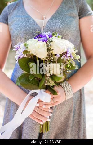 Bouquet with roses, chrysanthemums and white deren leaves Stock Photo