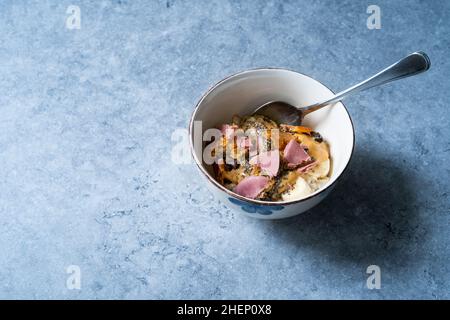 Porridge with Ruby Chocolate, Candied Orange Slices and Chia Seeds. Ready to Eat. Stock Photo
