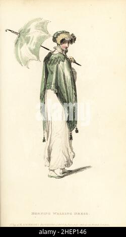 Regency woman in morning walking dress. Cambric or jaconot muslin robe with needlework at hem, Cossack mantle of Pomona green shot sarsnet, provincial poke bonnet of quilted satin, matching parasol and shoes, pale tan gloves. Plate 5, Vol. 10, July 1 1813.. Handcoloured copperplate engraving by Thomas Uwins from Rudolph Ackermann's Repository of Arts, London. Stock Photo