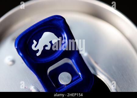 A closeup of a blue Red Bull icon on an opened can of Red Bull energy drink. Stock Photo