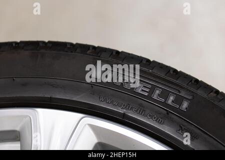 The Pirelli logo is on the tire of a new tire in a garage. Pirelli, an Italian tire manufacturer, is one of the largest in the world. Stock Photo