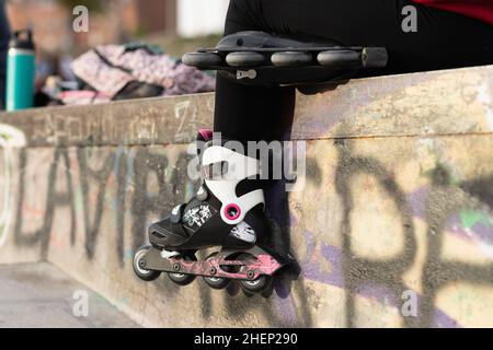 Close up view of inline skates on a person in skate park Stock Photo