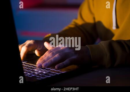 Hands types on a laptop keyboard. Stock Photo