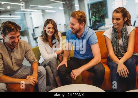 Group of happy multiethnic business people having fun and chatting at workplace office Stock Photo