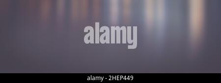 Blurred matte abstract background in blue and pink tones with gradient. Water texture with colored lights reflected in it at night. Stock Photo