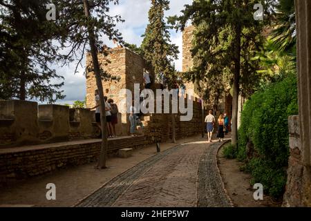 Tourists exploring the rampart walls inside Moorish fortress palace Alcazaba, Malaga, Andalusia, Spain Stock Photo
