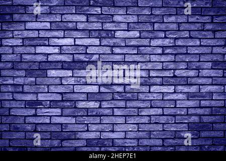 Brick wall of purple or violet masonry. Wall with small Bricks. Modern wallpaper design for web or graphic art projects. Abstract template or mock up. Stock Photo