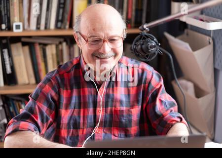 Senior businessman motivation speaker using video camera making video for blog Stock Photo