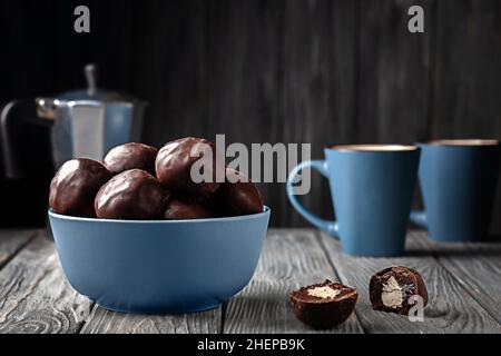Dark chocolate balls stuffed with marshmallows on wooden background Stock Photo