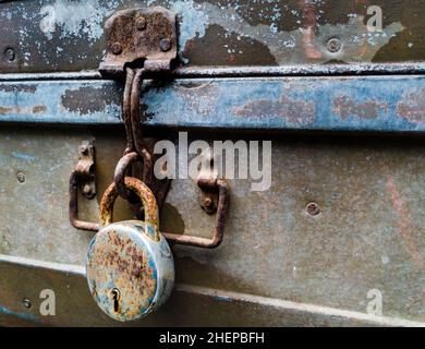 A close-up shot of an old vintage metal trunk with a big lock. Stock Photo