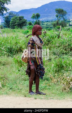 Tired Hamer Tribe Women coming back from Farm Work by the Green Rural Road Stock Photo