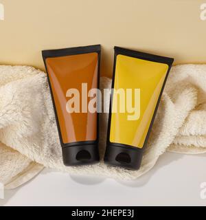 Color plastic tubes with body care product on towels Stock Photo