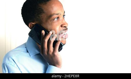 man talking on mobile telephone with neutral background Stock Photo