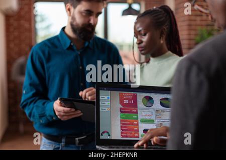 Diverse businesspeople analyzing company turnover working at marketing strategy discussing business collaboration in startup office. Multi-ethnic team brainstorming ideas for project Stock Photo