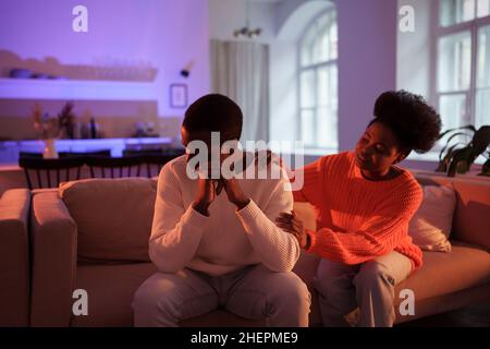 Young african woman trying to solve relationship problems without break up, biracial couple quarrel Stock Photo