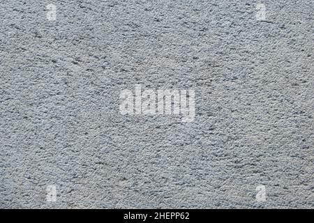 Part of the rough gray rough surface of the stone. Granite slab texture. Stock Photo