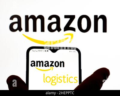 In this photo illustration, the Amazon Logistics logo is seen displayed on a smartphone screen and Amazon logo in the background. Stock Photo