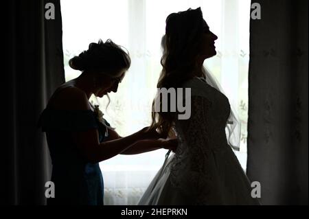 Dolyna, Ukraine June 26, 2021: the morning of the bride, pleasant petitions at home, the bride and her friend. Stock Photo