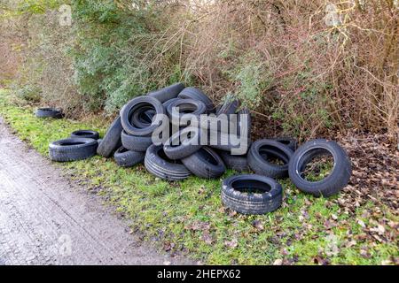 many used tires as garbage at open area without proper recycling Stock Photo