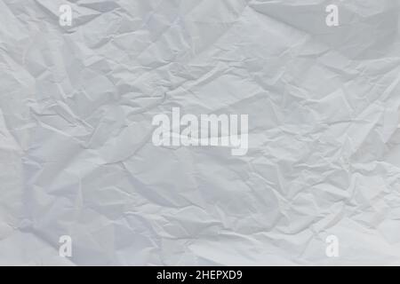 Crumpled white paper for gift wrapping or packaging. Closeup, texture background, pollution and recycling concept Stock Photo