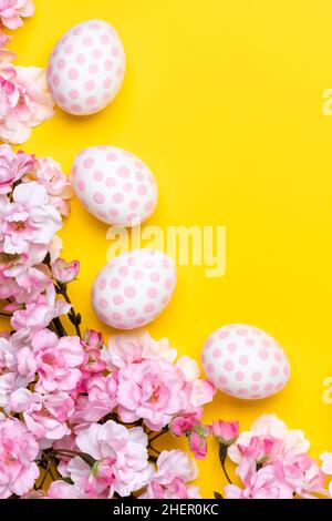 Easter background with polka dot paschal eggs, yellow paper template, greeting card with empty space for text. Spring season. Festive flat lay, beauti Stock Photo